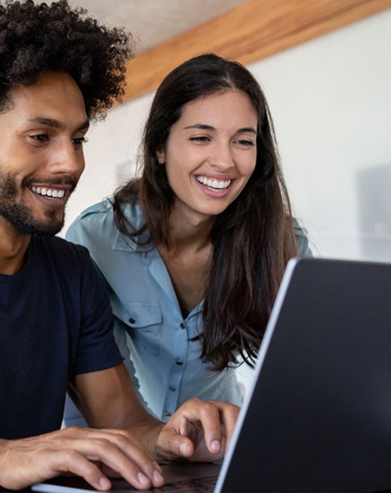 a couple looking at their laptop