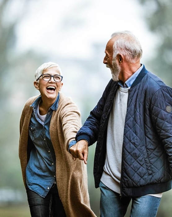 elderly couple walking by hand