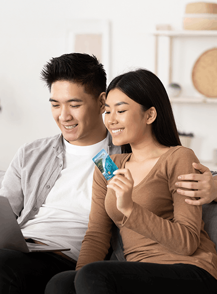 Couple using laptop and credit card